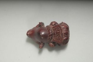 A CARVED HARDWOOD FROG NETSUKE. Signed. 2.25ins.