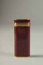 A CARTIER RED ENAMEL LIGHTER. No. 27628 in a velvet pouch.