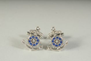 A PAIR OF SILVER SHIP'S WHEEL EMERALD CUFFLINKS, boxed.