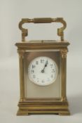 A GOOD FRENCH BRASS REPEATER CARRIAGE CLOCK with column sides, stamped E. M. & Co. 6ins high, in a