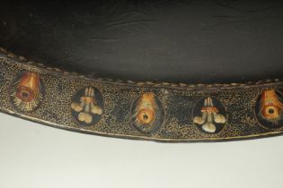 A SUPERB REGENCY PAPIER MACHE OVAL TWO HANDLED TEA TRAY, the border painted with Prince of Wales