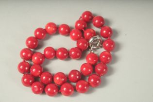 A STRING OF CORAL BEADS.