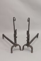 A GOOD PAIR OF EARLY WROUGHT IRON FIRE DOGS with curving tops. 31ins high, 28ins long.