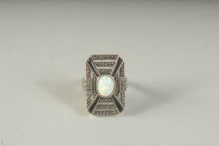 A SILVER ONYX AND OPAL ART DECO STYLE RING, boxed.