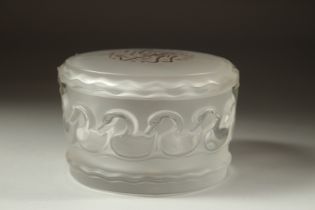 A LALIQUE FROSTED GLASS CIRCULAR POWDER BOWL AND COVER the lid with gilt calligraphy. Signed,