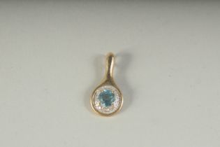 A GOOD 9CT GOLD BLUE TOPAZ AND DIAMOND PENDANT, boxed.