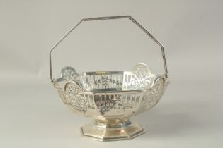 AN OCTAGONAL PIERCED SILVER BASKET with swing handle. Sheffield, 1910. Maker R & B, weight 18ozs.