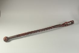 A MAHOGANY TILLER FROM AN ARTILLERY LAUNCH, 19TH CENTURY, spiral shape with knife. 38ins high.
