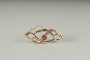 A 9CT GOLD RUBY SET BROOCH, boxed.