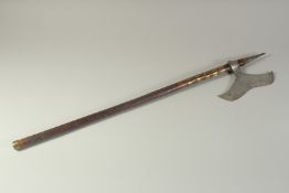 AN ASIAN WAR CLUB with wooden handle. 31ins long.