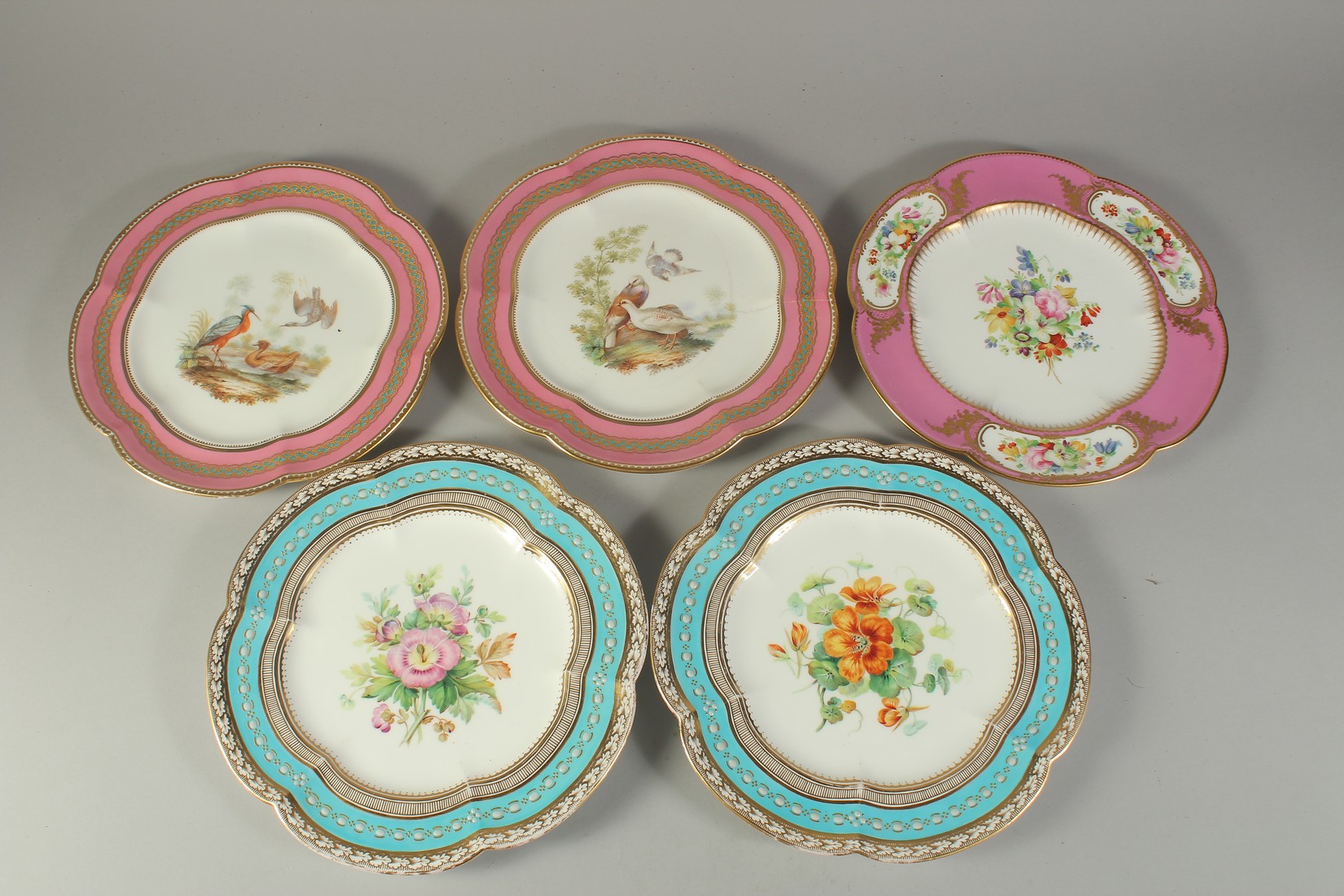 A PAIR OF PLATES painted with birds and three painted with flowers (3).