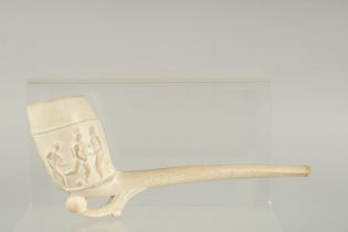 AN EARLY CLAY PIPE depicting footballers. 8.5ins long.