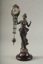 A BRONZED DIANA MYSTERY CLOCK on a circular wooden base. 11ins high.