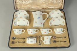 A GOOD MEISSEN PORCELAIN TEA SET in a fitted case, comprising jug with silver mounts, four cups