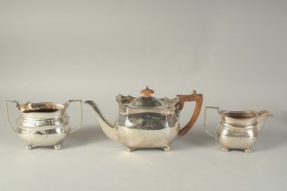 A GEORGE III ENGRAVED THREE PIECE TEA SET with shell engraving and bead edge. Sheffield 1809 & 1810.