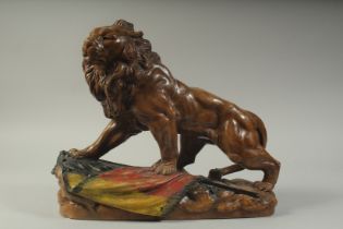 A GOOD TERRACOTTA LION on a rustic base. 18ins long.