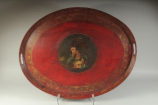 A LARGE OVAL REGENCY TOLEWARE TRAY with hand apertures, the centre painted with a mother and