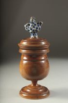 A GOOD TREEN JAR AND COVER. 9ins high.