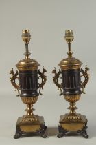 A PAIR OF 19TH CENTURY FRENCH TWO HANDLED URN SHAPED LAMPS. 14ins high.