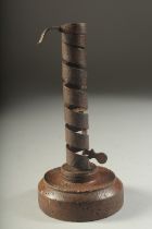 AN EARLY WOODEN AND METAL CANDLESTICK. 8ins high.