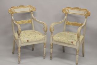 A PAIR OF CARVED, PAINTED AND PARCEL GILDED OPEN ARMCHAIRS, with floral upholstered overstuffed