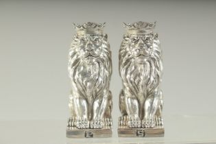 A PAIR OF SILVER PLATE ROYAL LION SALT AND PEPPERS. 8.5cms high.