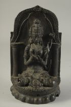 A FINE 19TH CENTURY OR EARLIER BRONZE SEATED DEITY, 23.5cm high.