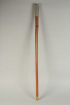 A CHINESE WOODEN WALKING STICK WITH EMBOSSED SILVER TOP, 86cm long.