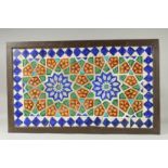 A FINE LARGE 19TH CENTURY INDIAN GLAZED POTTERY TILED PANEL, inset within a wooden frame; possibly a