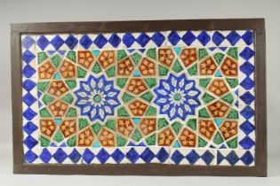 A FINE LARGE 19TH CENTURY INDIAN GLAZED POTTERY TILED PANEL, inset within a wooden frame; possibly a