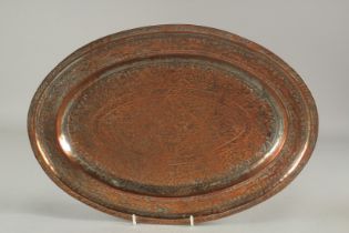 A QAJAR ENGRAVED TINNED COPPER OVAL TRAY, 41cm x 28.5cm.