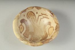 A RARE SMALL 9TH-10TH CENTURY MESOPOTAMIAN ABBASID COPPER LUSTRE GLAZED POTTERY BOWL, painted with