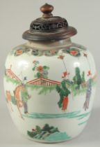 A CHINESE FAMILLE VERTE PORCELAIN JAR AND HARDWOOD COVER, finely decorated with a procession