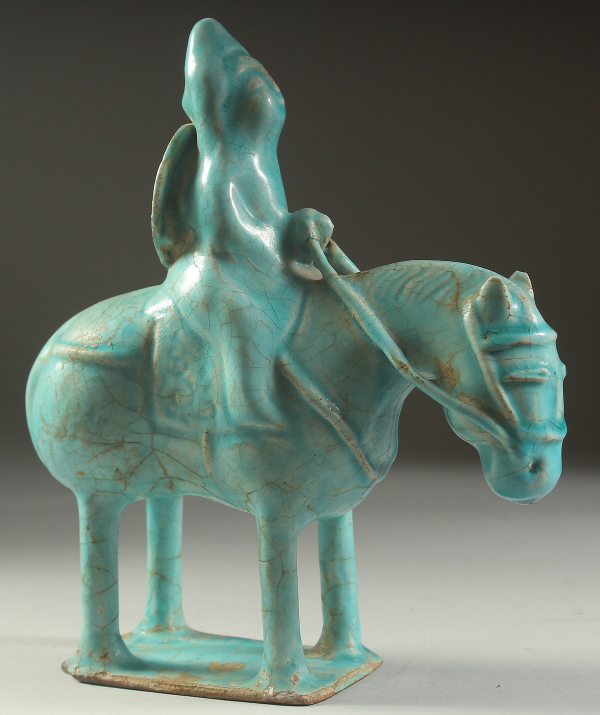 A VERY FINE AND RARE PERSIAN KASHAN TURQUOISE GLAZED POTTERY HORSE AND RIDER, 23.5cm high, 20cm