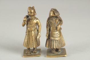 TWO EARLY 19TH CENTURY INDIAN BRASS CHESS PIECES, of a male and female, tallest 7cm high.