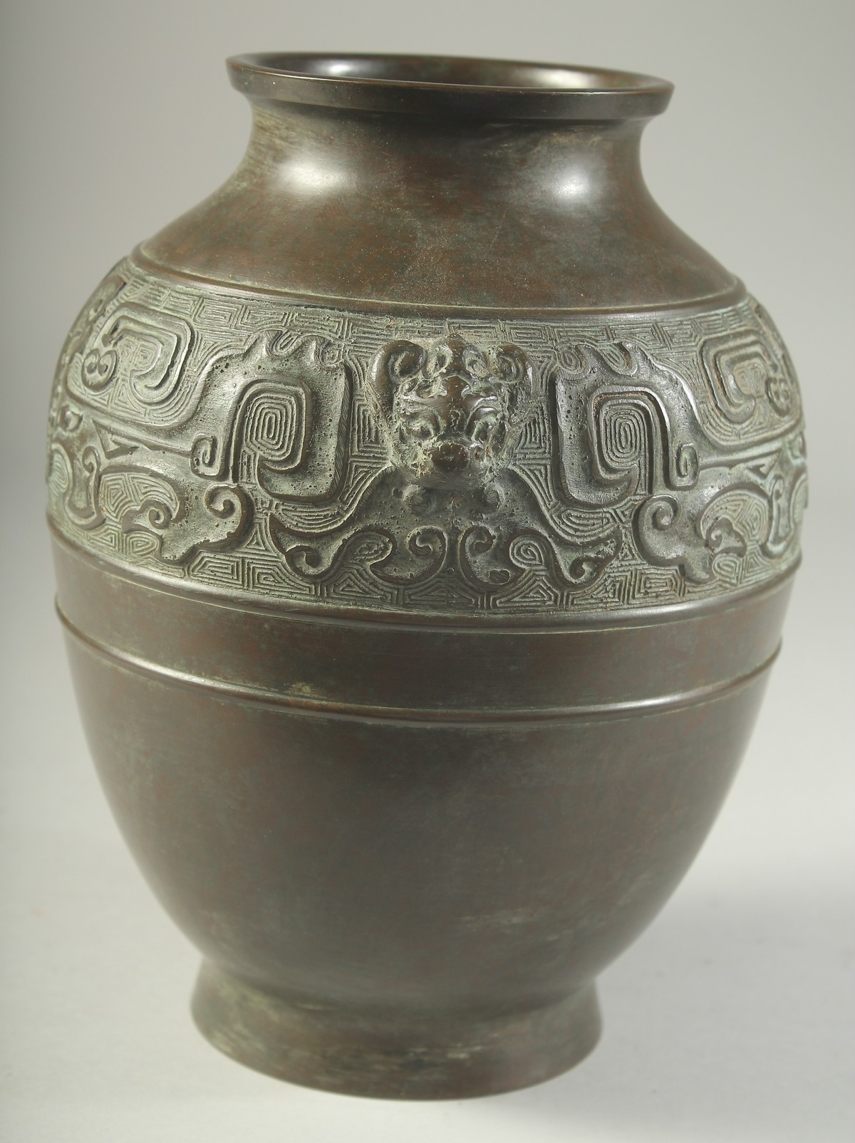 A CHINESE BRONZE VASE, with a band of archaic design and twin beast-head handles, 22cm high. - Image 2 of 6