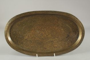 A 19TH CENTURY QAJAR ENGRAVED BRASS OVAL TRAY, 38cm x 21.5cm.