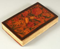 A FINE PERSIAN QAJAR LACQUERED COVER QURAN, signed and dated, the covers painted with flora, 15cm