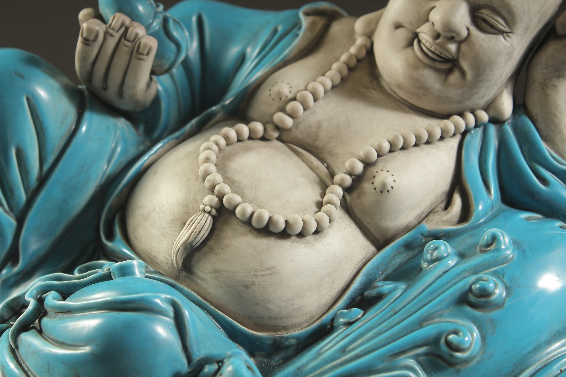 A LARGE TURQUOISE GLAZED POTTERY HAPPY BUDDHA, in reclining position with coiled dragon at his feet, - Image 3 of 7