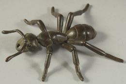A LARGE BRONZE OKIMONO OF AN ANT, with articulated legs, 10.5cm long.