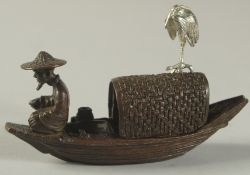 A BRONZE OKIMONO OF A FISHERMAN IN A BOAT, with silver crane to the top, 10cm long.