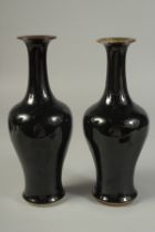 A PAIR OF CHINESE NOIR GLAZE PORCELAIN VASES, (repair), 23.5cm high.