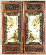 A PAIR OF CHINESE REPUBLIC PORCELAIN ENAMELLED PANELS, inset within wooden frames.