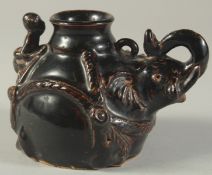 A CHINESE JIZHOU BLACK GLAZED POTTERY WATER DROPPER, in the form of an elephant with a monkey to the