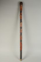 A CHINESE BAMBOO WALKING STICK, carved with fish, 90cm long.
