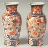 A PAIR OF JAPANESE IMARI PORCELAIN VASES, with floral decoration and heightened with gilt