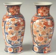 A PAIR OF JAPANESE IMARI PORCELAIN VASES, with floral decoration and heightened with gilt