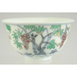 A CHINESE DOUCAI PORCELAIN CUP, decorated with fruits, base with character mark, 8cm diameter.