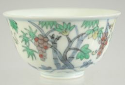 A CHINESE DOUCAI PORCELAIN CUP, decorated with fruits, base with character mark, 8cm diameter.
