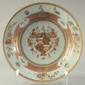 A LARGE CHINESE EXPORT ARMORIAL DISH, with central crest, finely painted with fruits and flora,